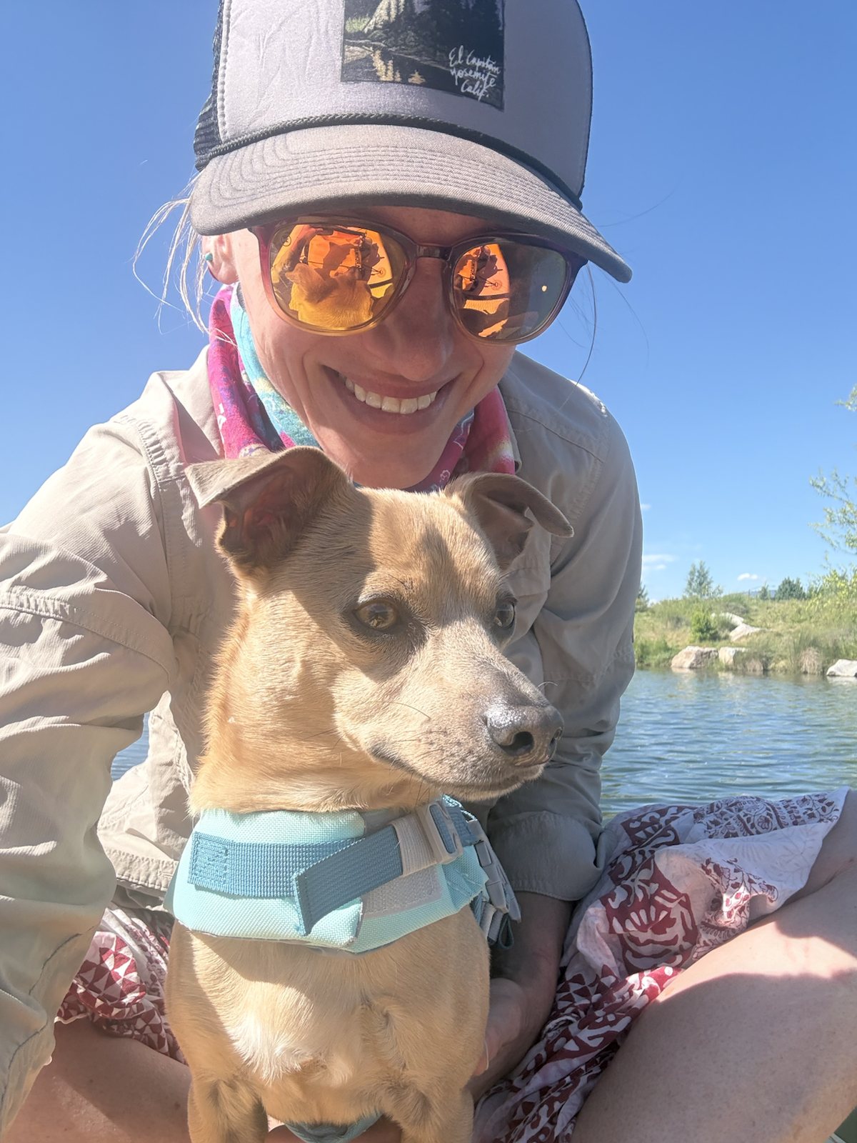 Chasta smiling with Tennessee Jed beside the water